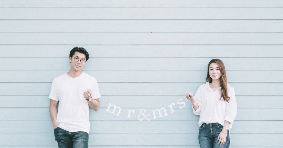 content young asian married couple in casual clothes holding garland with mr and mrs standing near b