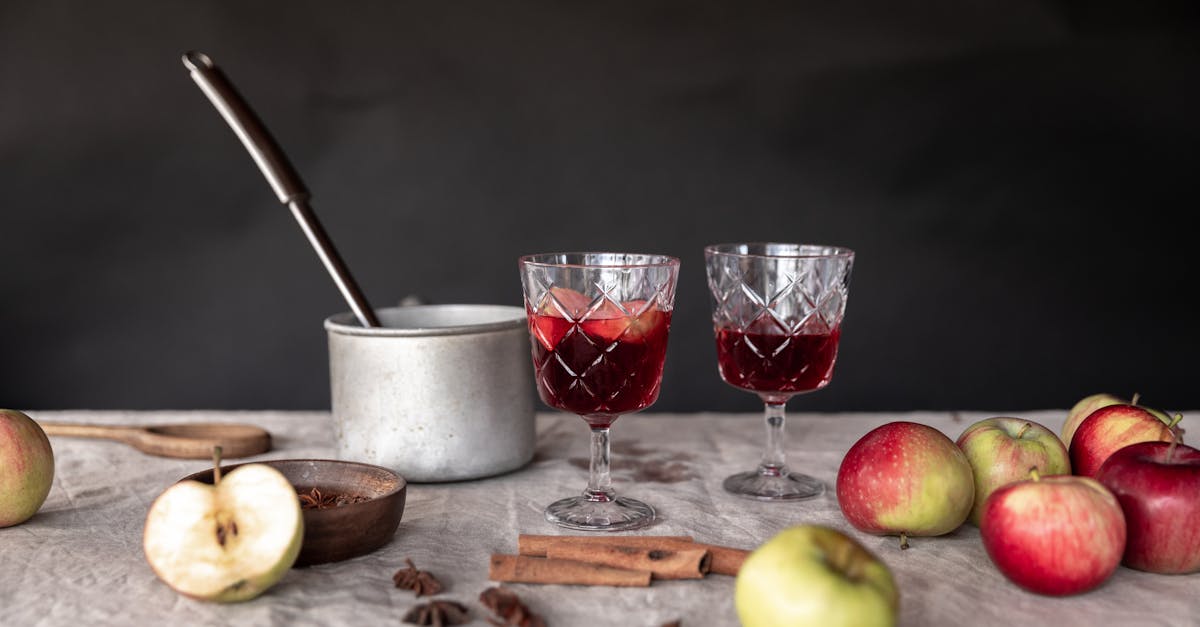 cozy autumn setup with apples cinnamon and mulled wine in elegant glasses 2