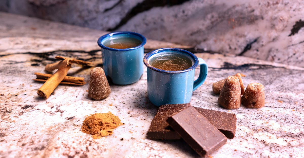 cozy blue mugs of hot chocolate with spices and brown sugar on a rustic surface