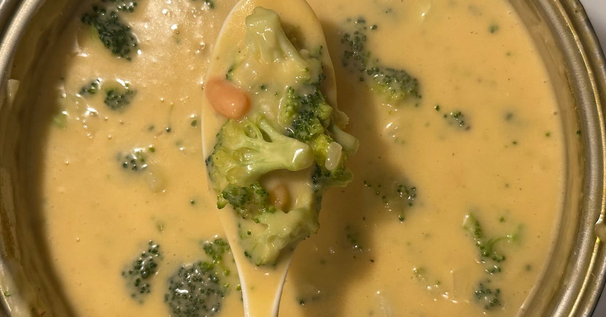 creamy broccoli cheese soup in a pot with spoonful of vegetables perfect comfort food 1