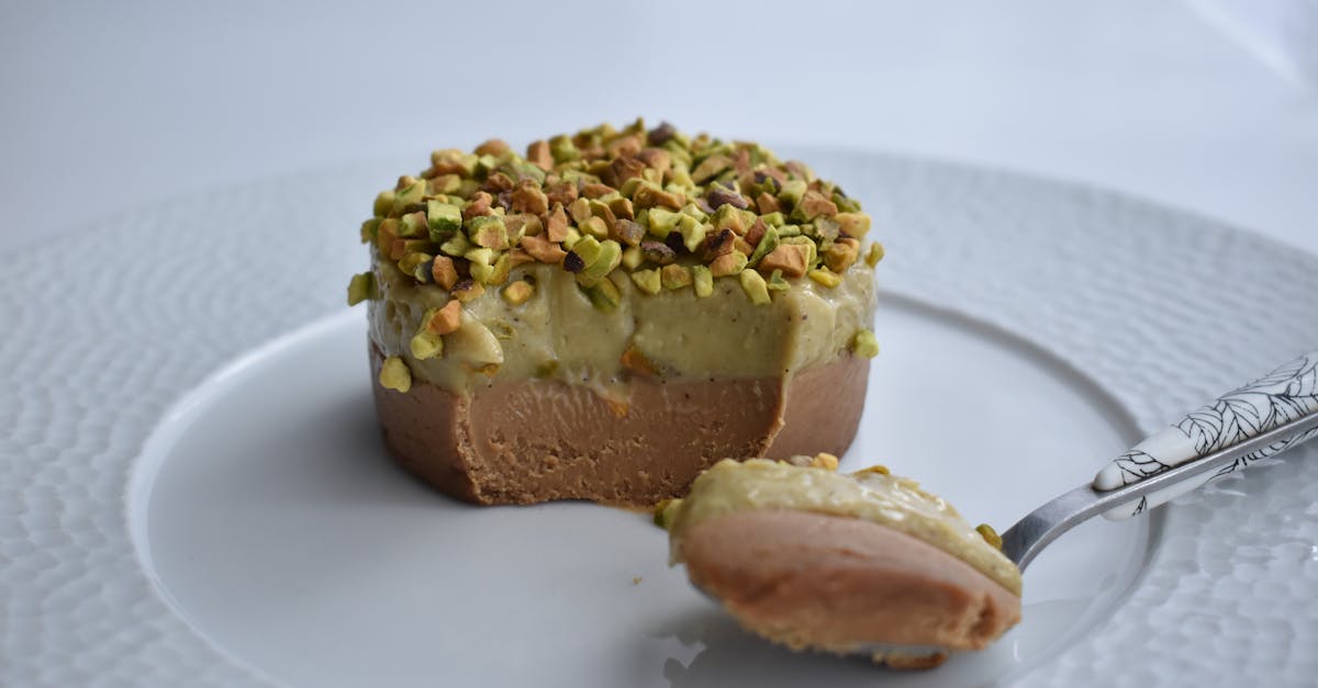 creamy dessert topped with pistachios on a white plate ready to enjoy 1
