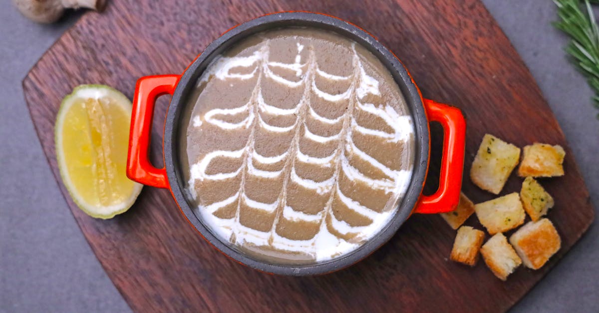 creamy mushroom soup garnished with herbs and croutons served in a bowl