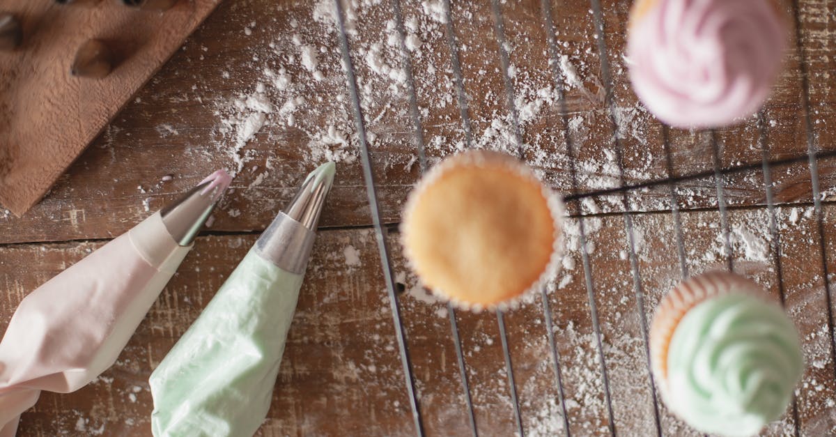 cupcakes with decorative frosting on a rustic wooden table with baking tools