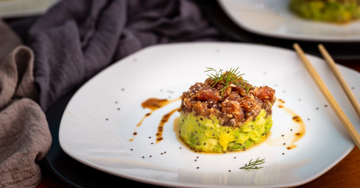 delicious avocado tartare with herbs and sauce presented on a white plate perfect for a gourmet lun