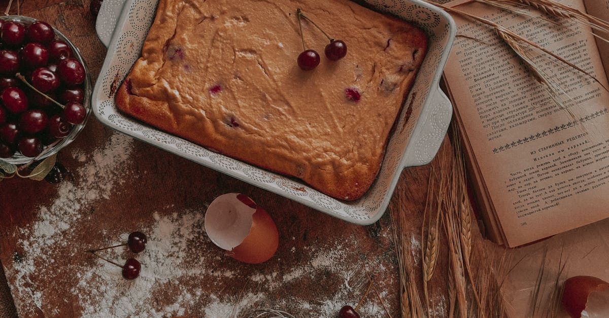 delicious cherry cake in a rustic setting with eggshells flour and open cookbook for baking inspir