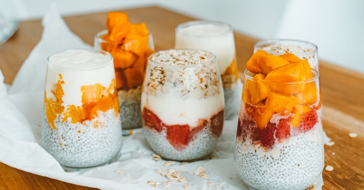 delicious chia pudding parfaits with mango and strawberry layers on a wooden table 2