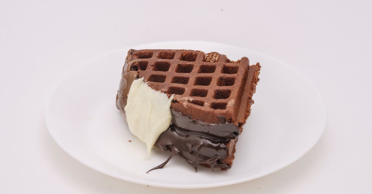 Home delicious chocolate waffle with dark and white chocolate coating on a white plate 1