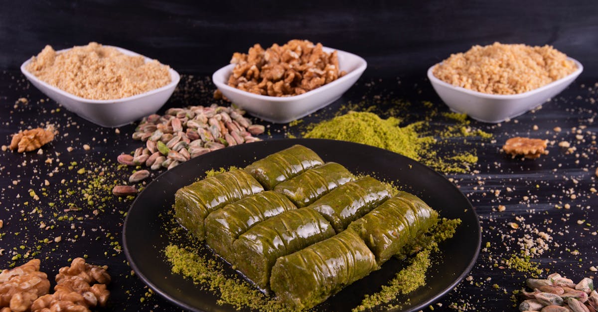 delicious close up of baklava rolls garnished with pistachios and walnuts on a rustic plate