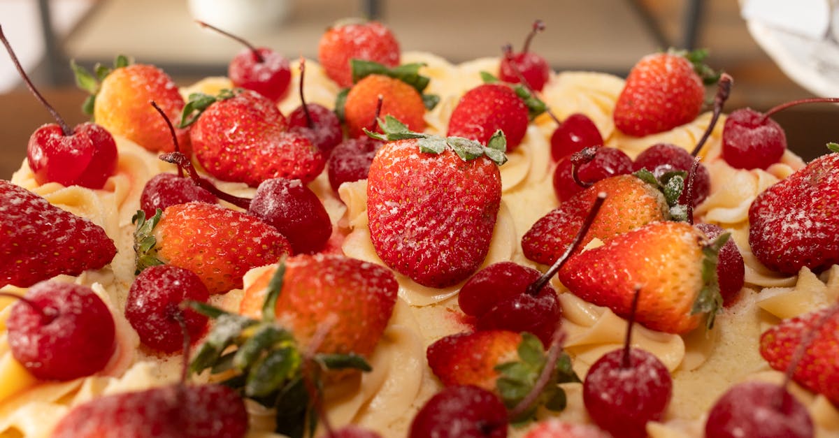 delicious cream cake decorated with fresh strawberries and cherries