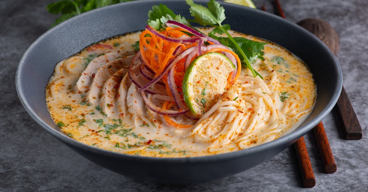 delicious creamy noodle soup garnished with vegetables and spices perfect fusion dish for food love