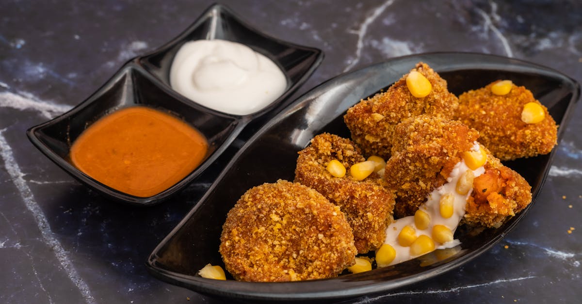 delicious crispy cheese corn momos served with spicy and creamy sauces on a marble surface 2