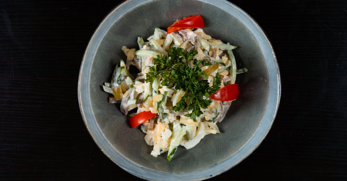 delicious fresh vegetable salad topped with parsley served in a ceramic bowl
