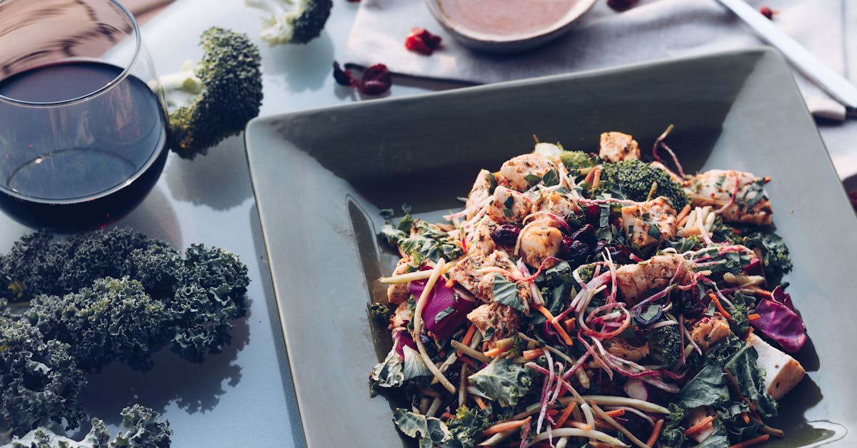 delicious grilled chicken salad with kale broccoli and wine on a stylish table setting 2
