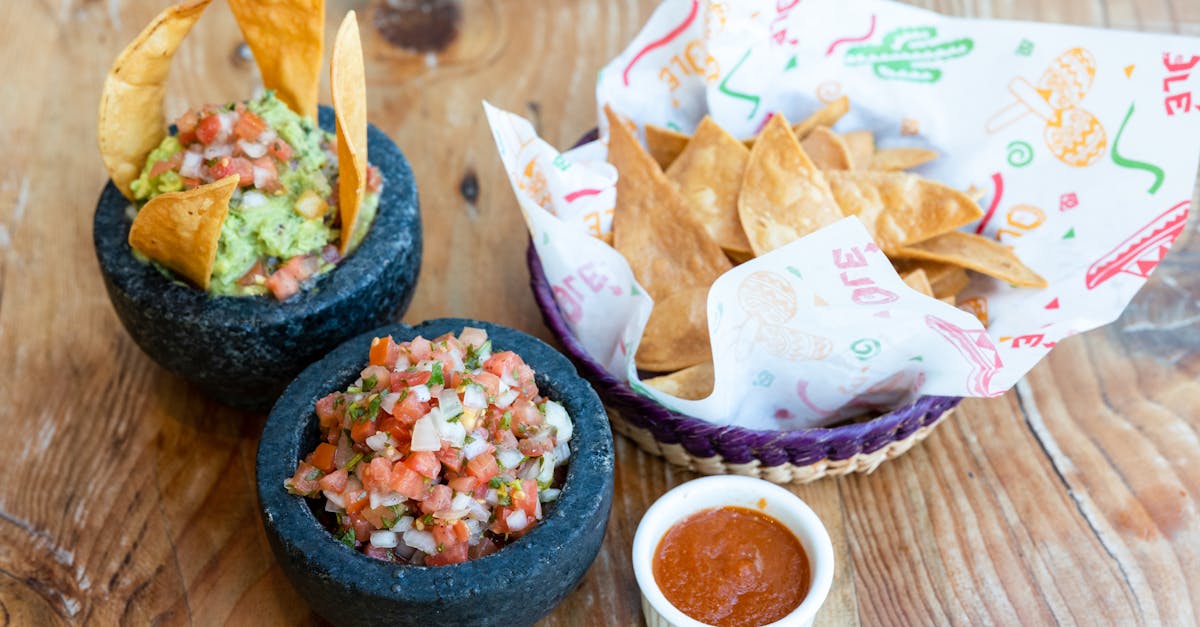 delicious guacamole and salsa served with crispy tortilla chips on a wooden table 2