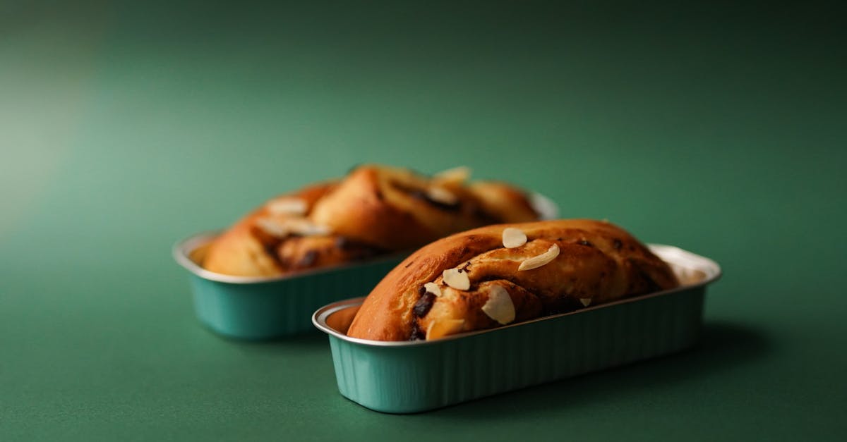 delicious homemade almond bread in blue tins on a green backdrop perfect for culinary presentations 2