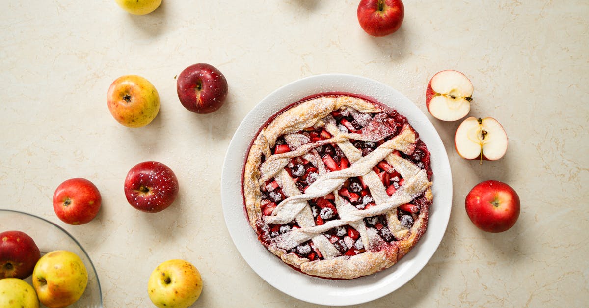 delicious homemade apple pie with lattice crust surrounded by fresh apples on a marble surface 2