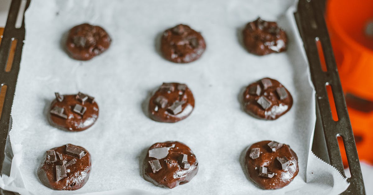 delicious homemade chocolate chunk cookies on a parchment lined baking tray ready for baking 3
