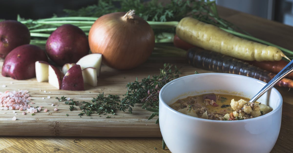 delicious homemade vegetable soup with fresh ingredients on a wooden table