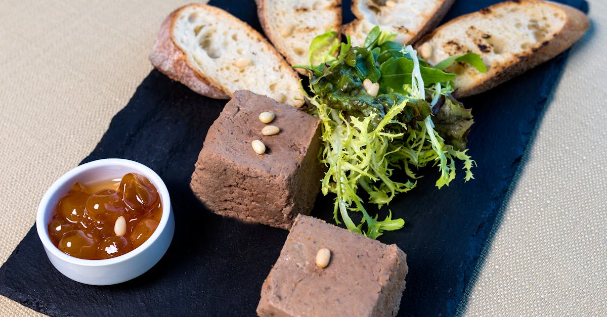 delicious liver pate with toasted baguette salad and chutney on a slate serving board