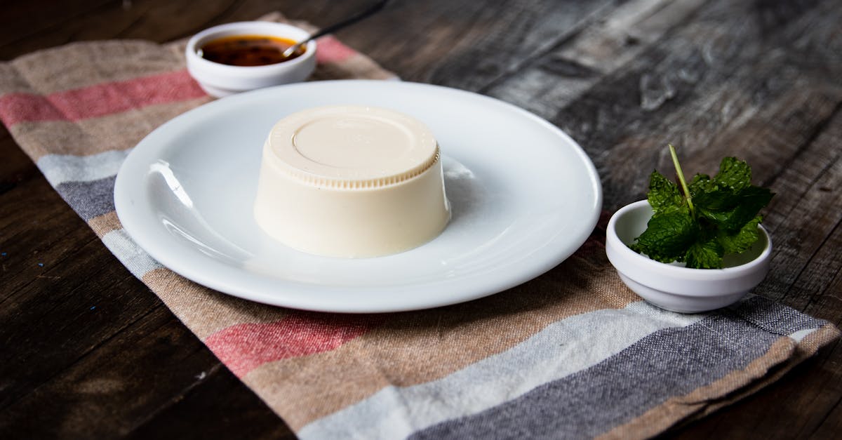 delicious panna cotta served with fresh mint and sauce on a rustic table setting
