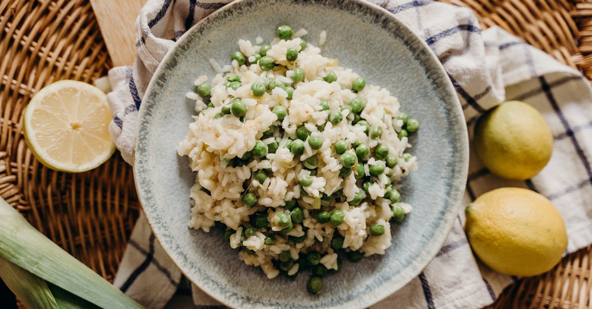delicious risotto filled with green peas served with fresh lemons on a rustic wicker setup 3