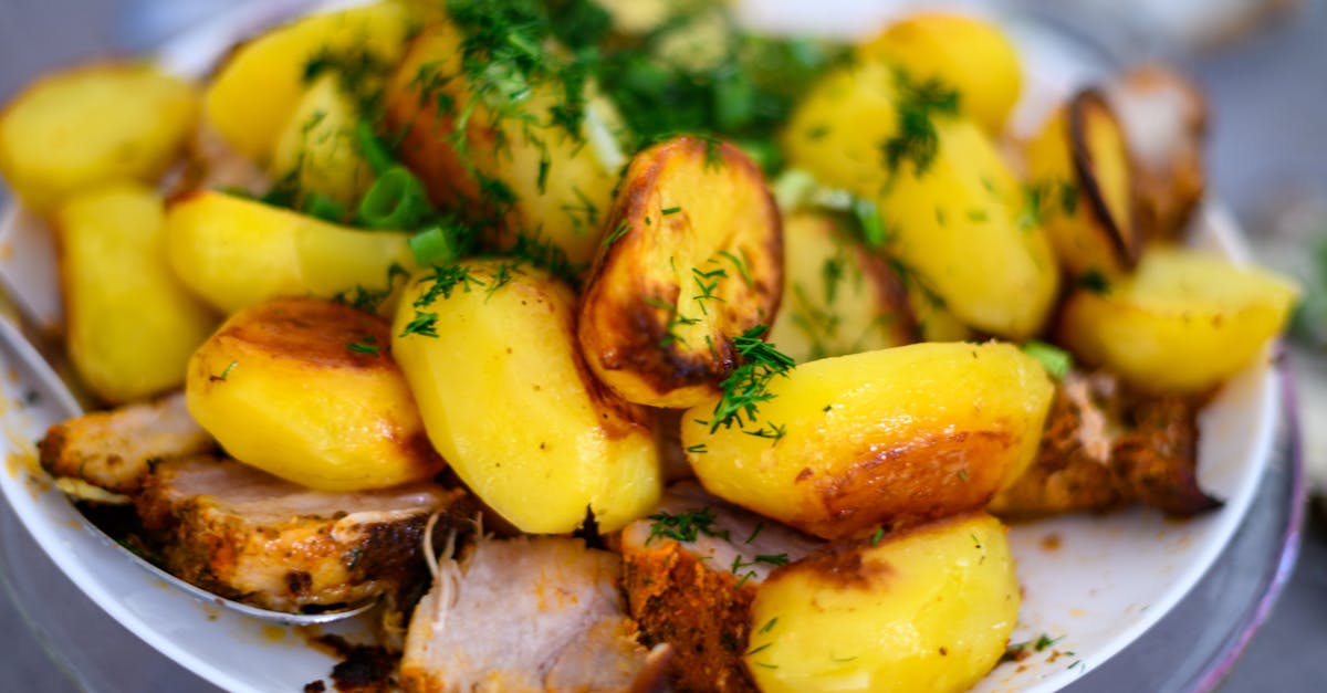 delicious roasted potatoes and meat garnished with fresh dill perfect for a hearty meal