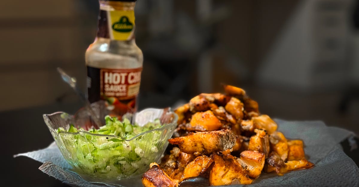delicious roasted potatoes paired with hot sauce and fresh salad indoors 1