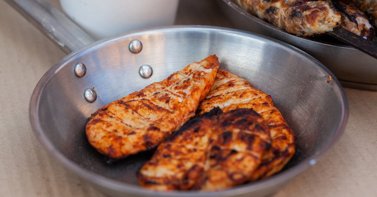 delicious seasoned chicken breasts grilled and served in a stainless steel pan 1