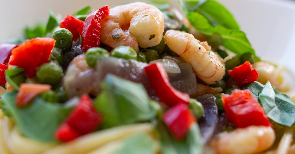 delicious shrimp pasta garnished with fresh vegetables and herbs perfect for a healthy meal