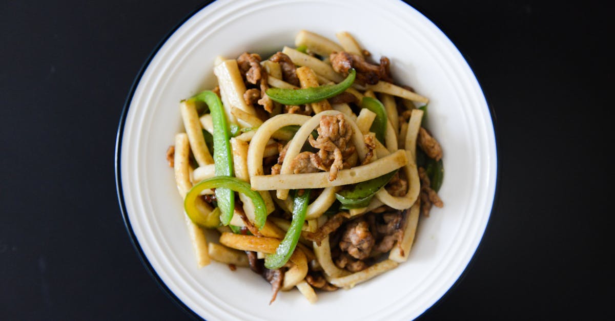 delicious stir fried udon noodles with pork and fresh vegetables on a plate 1