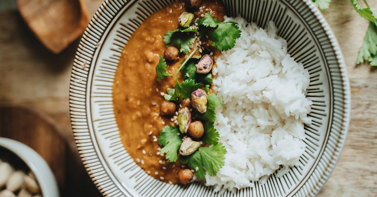 delicious vegan rice bowl featuring lentil curry topped with pistachios cilantro and sesame seeds 2