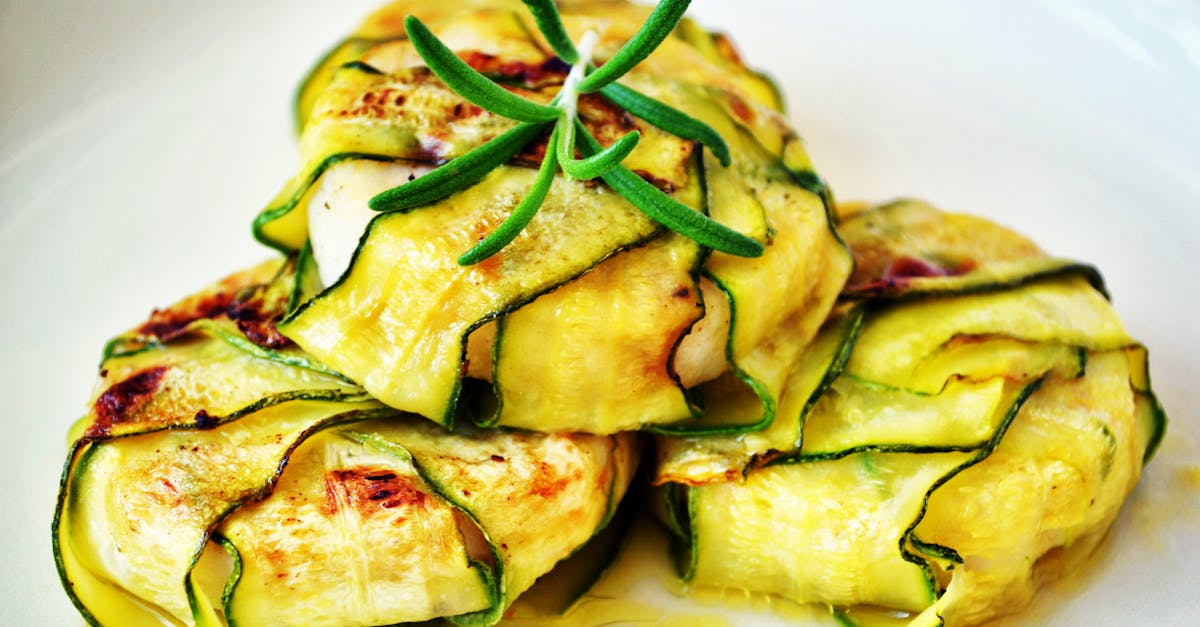 delicious zucchini wraps stuffed with grilled chicken presented with fresh rosemary garnish