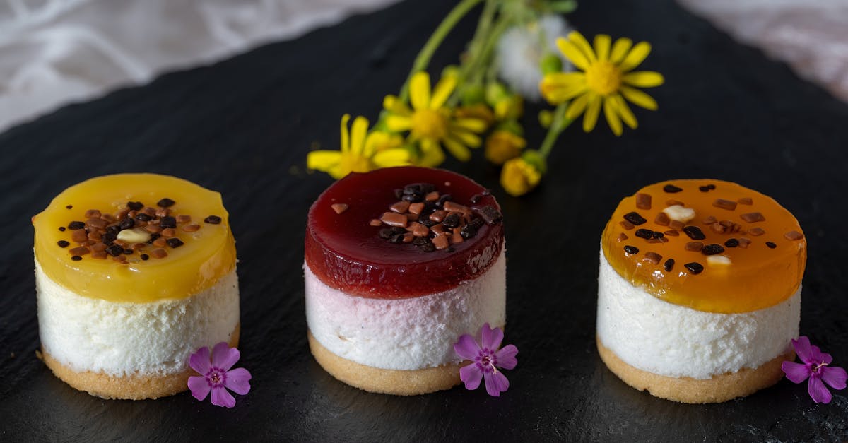 delight in colorful mini fruit cheesecakes beautifully garnished with flowers on a dark slate platt