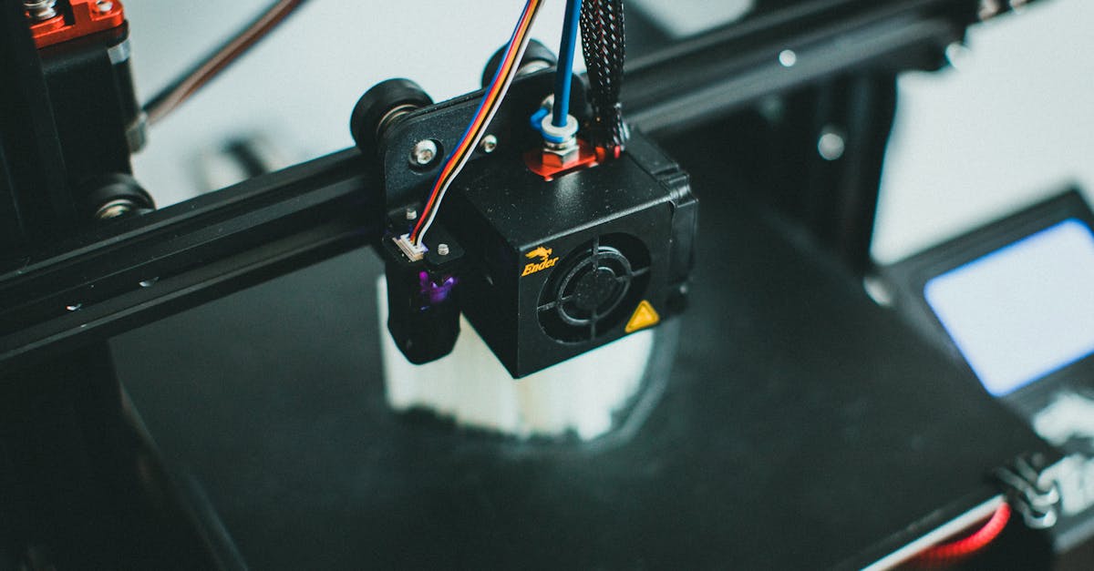 detailed shot of a 3d printer creating an object focusing on the cooling fan and print head