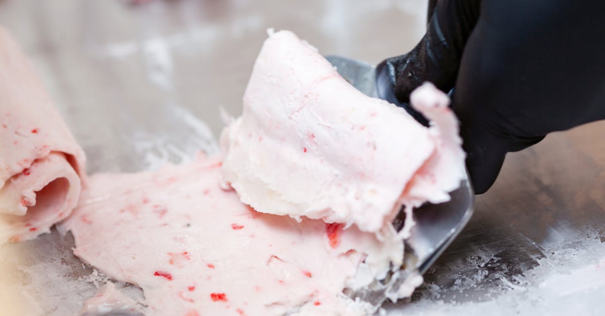 detailed view of strawberry rolled ice cream being crafted on a frozen surface 21