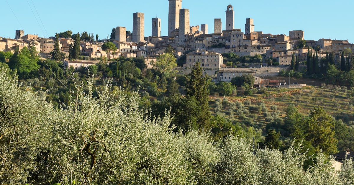 dramatic skyline of historic san gimignano with iconic towers amidst lush tuscan landscape