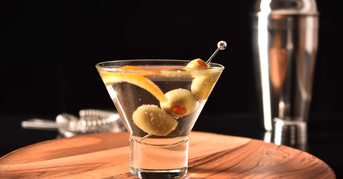 elegant martini cocktail with olives garnished on a wooden tray perfect for cocktail hour