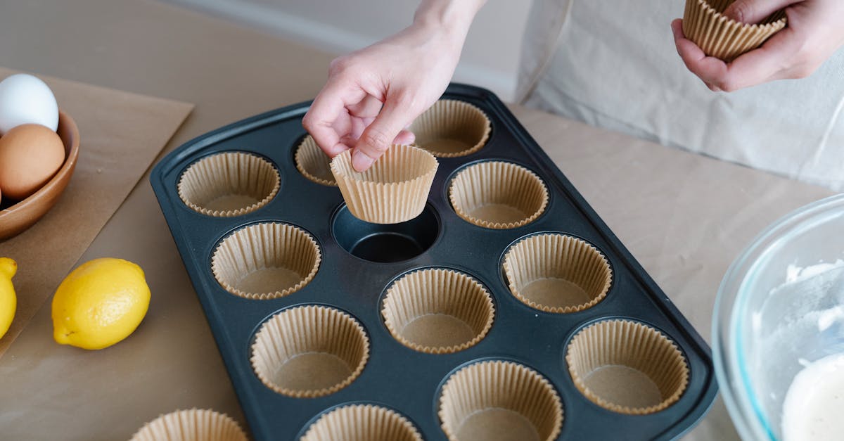 female preparing cupcake tray with baking ingredients like eggs and lemons on kitchen counter 9
