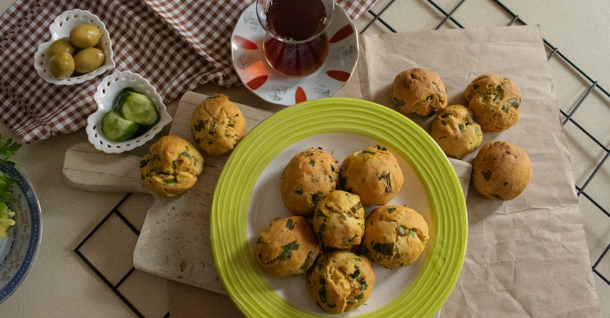 flat lay of homemade herb muffins with tea olives and cucumber slices styled on a kitchen counter