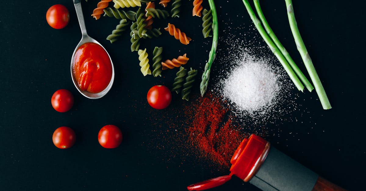 flatlay of fresh italian ingredients including pasta tomatoes and spices on a dark blue background 1