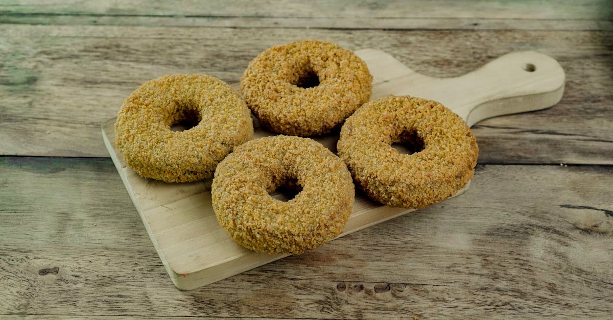 four breaded donuts on a rustic wooden cutting board perfect for food photography