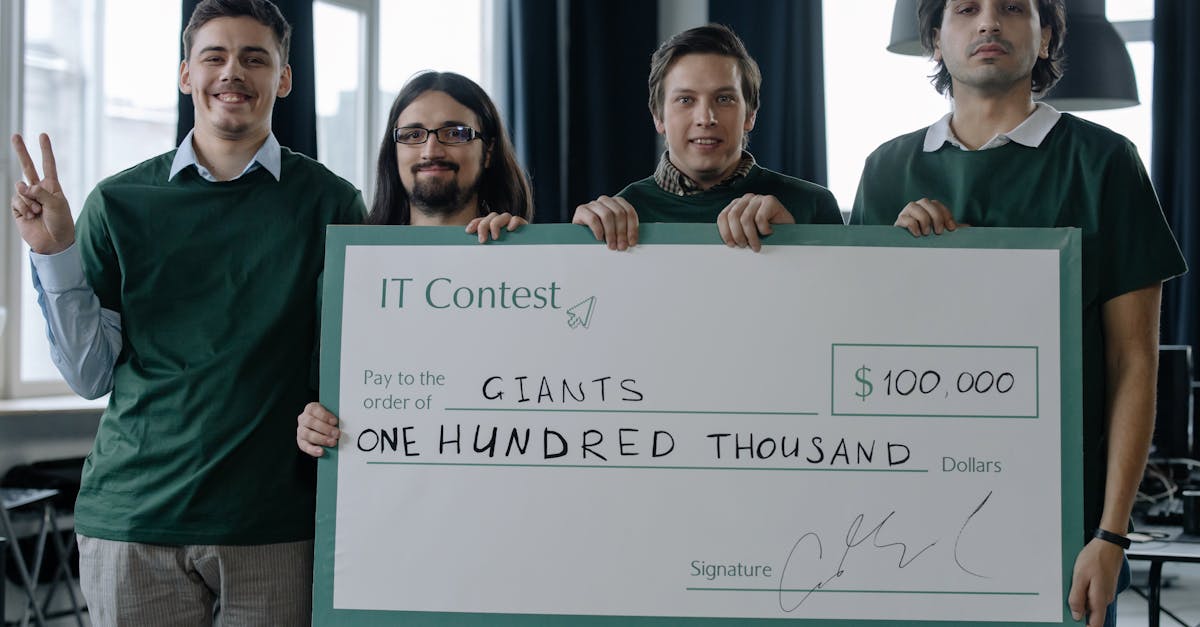 four men celebrate a 100 000 it contest victory holding a large cheque inside a modern office