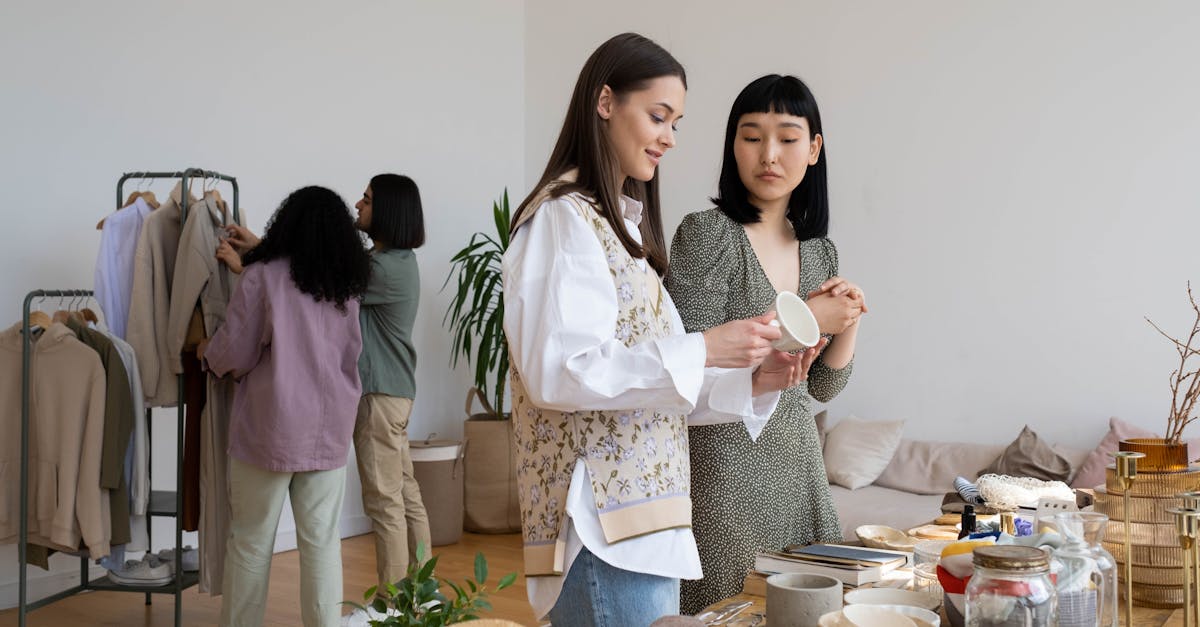 four women browsing clothes and items at an indoor swap party focused on sustainable living