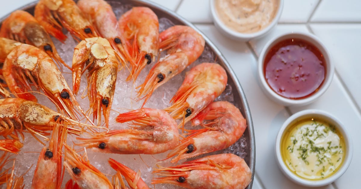 fresh shrimps on ice with flavorful dipping sauces in a vibrant food presentation