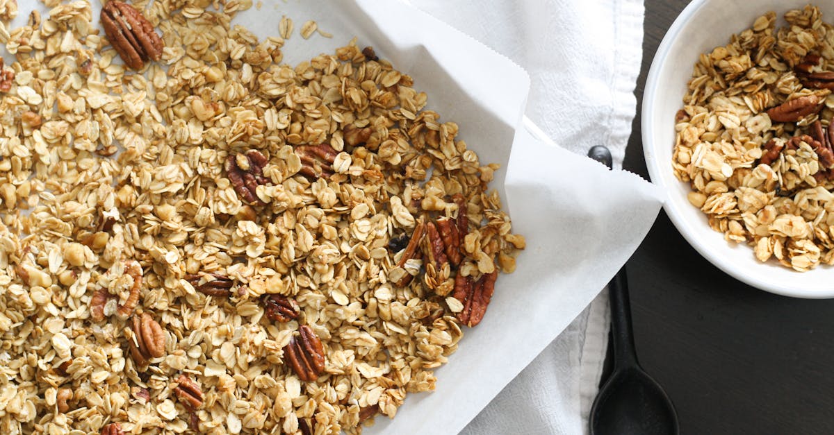 freshly baked granola with oats and pecans on parchment paper perfect for a healthy snack