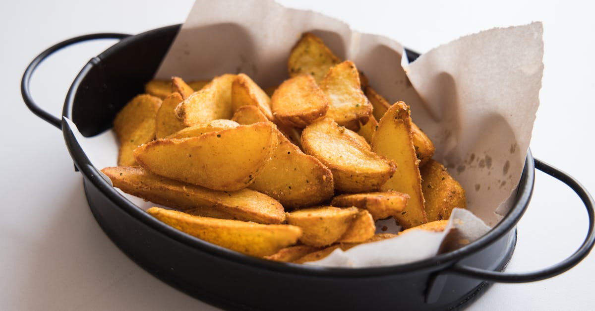 freshly baked potato wedges served in a stylish black bowl perfect for a snack or appetizer 2