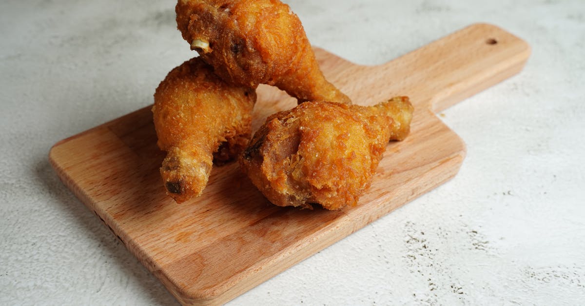 golden fried chicken drumsticks placed on a wooden cutting board perfect for a hearty meal 1