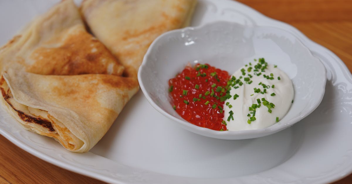 gourmet crepes served with red caviar and cream perfect for luxurious dining