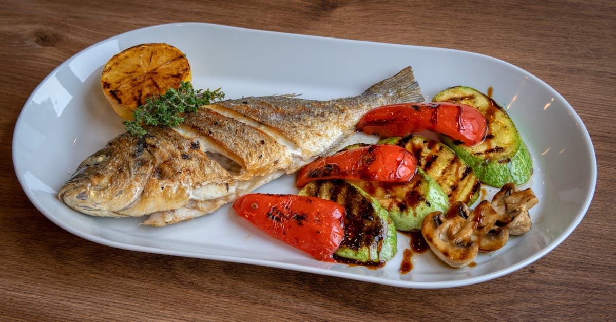 grilled fish served with roasted vegetables on a ceramic plate 17