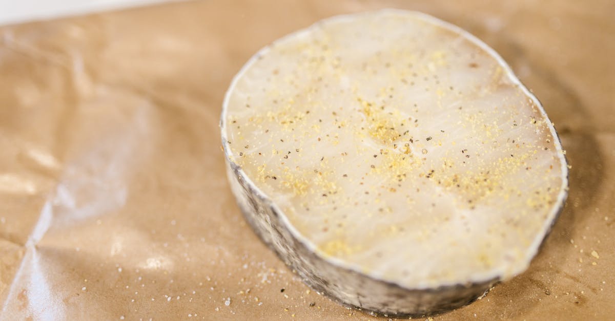 high quality image of a raw fish fillet with seasoning placed on paper ready for cooking